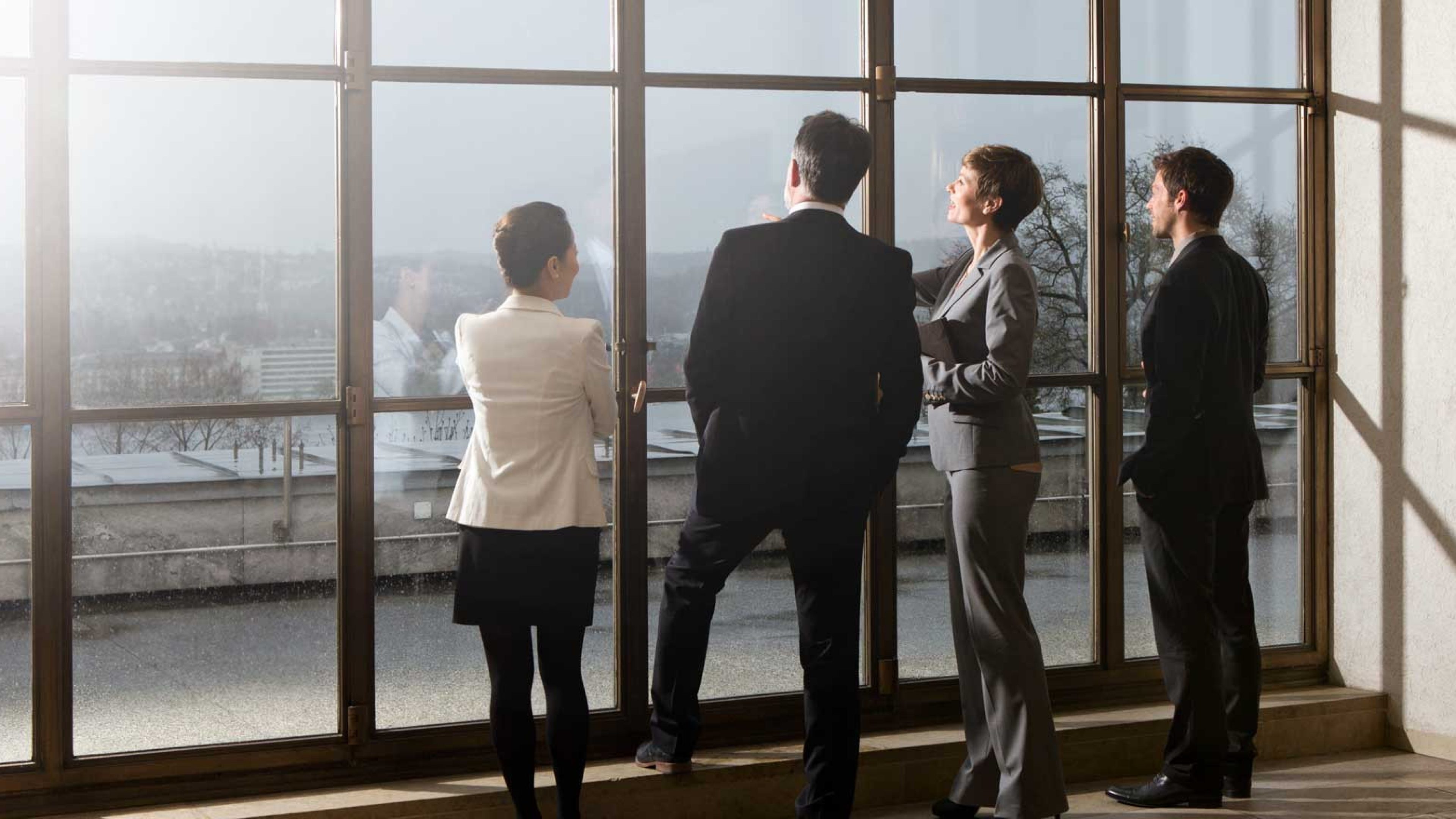 Employees looking out through a building window